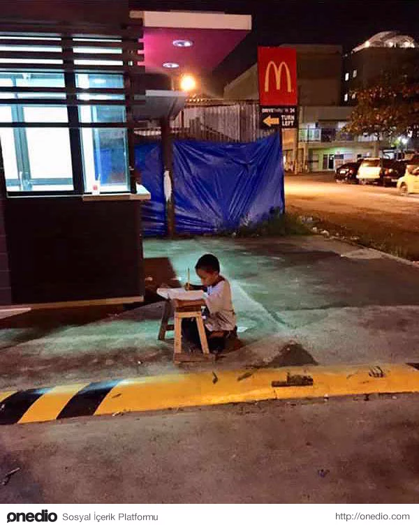 McDonalds'ın ışığında ödevini yapmaya çalışan bu evsiz çocuk.